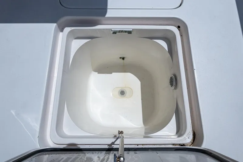 Slide: The Image of Livewell compartment on a 2005 Viking 61 yacht, featuring a clean, white interior. - 30