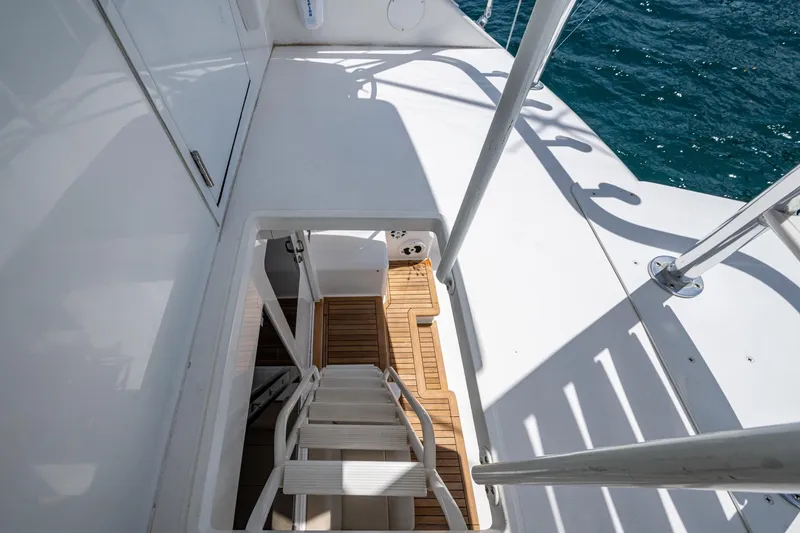 Slide: The Image of Staircase on 2005 Viking 61 yacht leading to lower deck, with ocean view. - 32