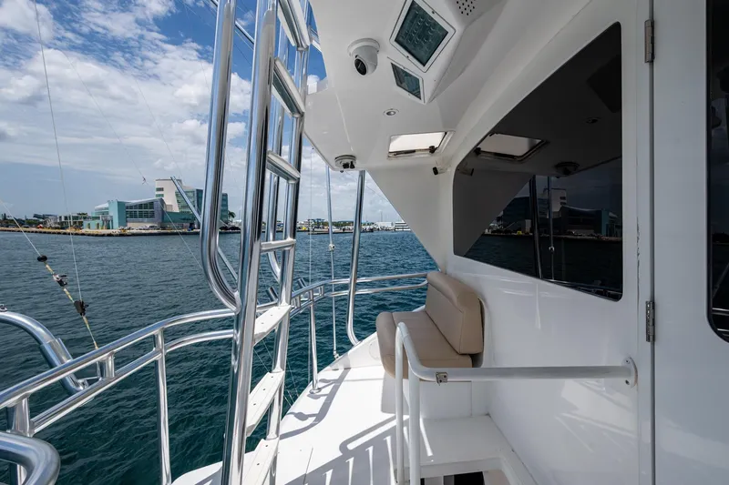 Slide: The Image of 2005 Viking 61 yacht deck with ocean view and modern architecture in background. - 33