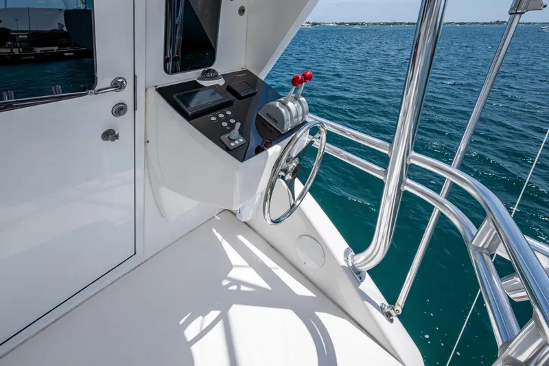 Slide: The Image of Control station of a 2005 Viking 61 yacht overlooking the ocean. - 35