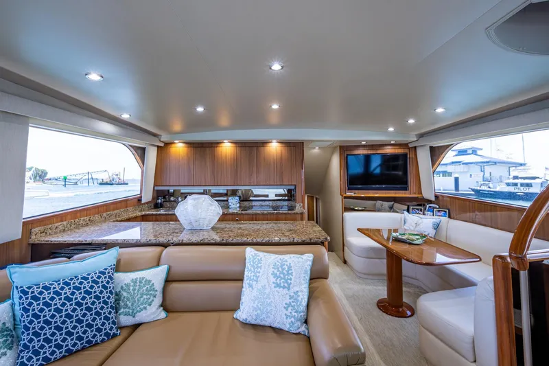 Slide: The Image of Luxurious interior of a 2005 Viking 61 yacht with elegant seating and modern amenities. - 38