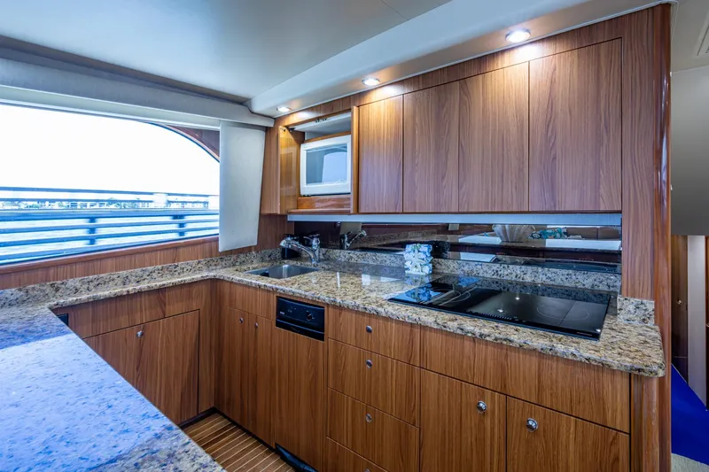 Slide: The Image of Luxurious kitchen interior of 2005 Viking 61 yacht with granite countertops and wooden cabinetry. - 42