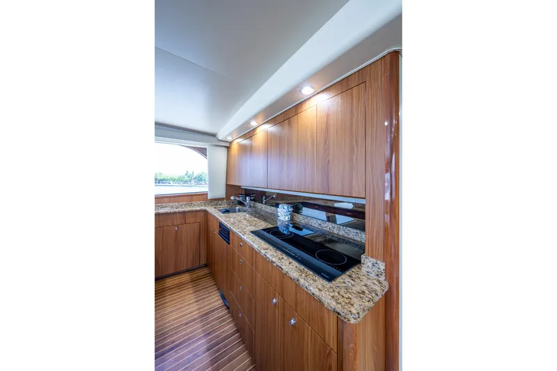 Slide: The Image of Luxurious kitchen interior of 2005 Viking 61 yacht with wood cabinetry and granite countertops. - 43