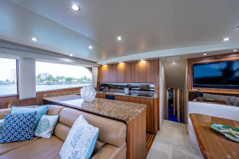 Slide: The Image of Luxurious interior of a 2005 Viking 61 yacht with elegant wood finishes and plush seating. - 48