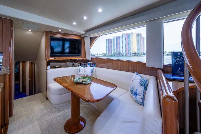 Slide: The Image of Luxurious interior of 2005 Viking 61 yacht with elegant seating and scenic window view. - 49