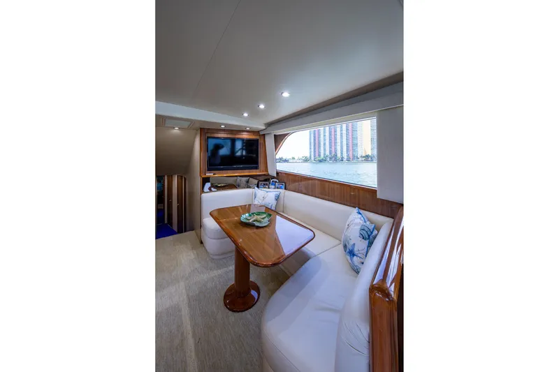 Slide: The Image of Luxurious interior of 2005 Viking 61 yacht with elegant seating and scenic window view. - 51