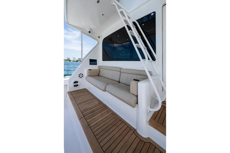 Slide: The Image of Luxurious 2005 Viking 61 yacht interior with beige seating and wooden flooring. - 54