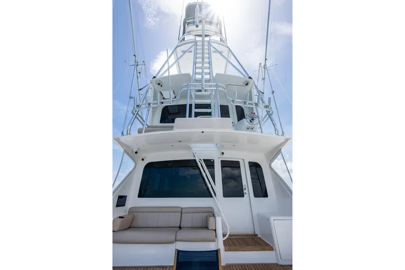 Slide: The Image of 2005 Viking 61 yacht, rear view with tower and seating, under clear blue sky. - 57