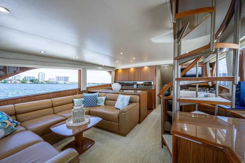 Slide: The Image of Luxurious interior of 2005 Viking 61 yacht with elegant seating and spiral staircase. - 62