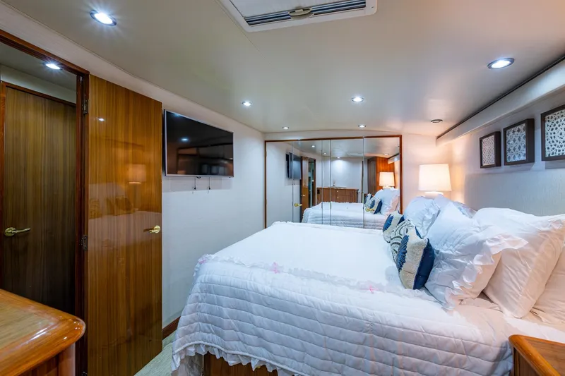 Slide: The Image of Luxurious bedroom interior of a 2005 Viking 61 yacht with elegant decor and cozy lighting. - 63