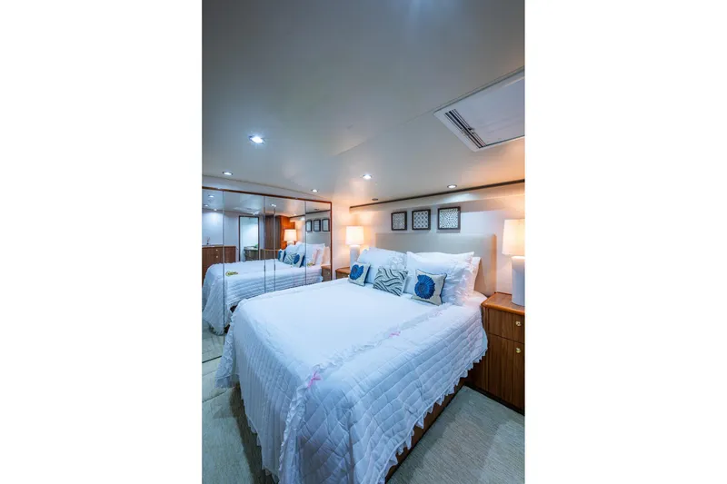 Slide: The Image of Luxurious bedroom interior of 2005 Viking 61 yacht with elegant bedding and ambient lighting. - 66
