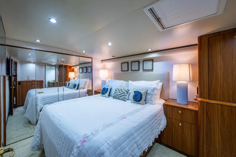 Slide: The Image of Luxurious bedroom interior of 2005 Viking 61 yacht with elegant decor and ambient lighting. - 69