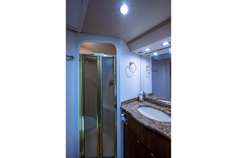 Slide: The Image of Luxurious bathroom in 2005 Viking 61 yacht with granite countertop and glass shower. - 70