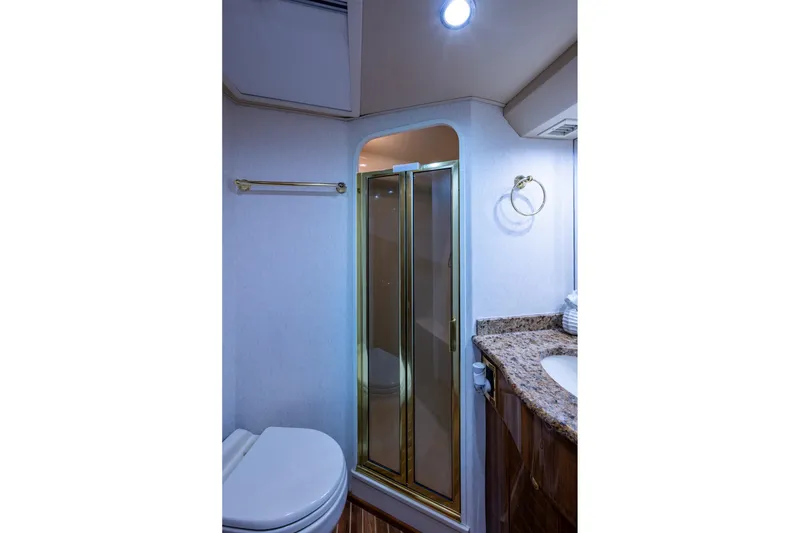 Slide: The Image of Luxurious bathroom in 2005 Viking 61 yacht with shower, granite countertop, and modern fixtures. - 71