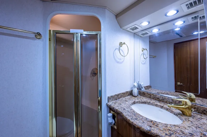 Slide: The Image of Luxurious bathroom in 2005 Viking 61 yacht with granite countertop and glass shower. - 72