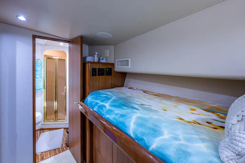Slide: The Image of Cozy cabin interior of 2005 Viking 61 yacht with bed and ensuite bathroom. - 73