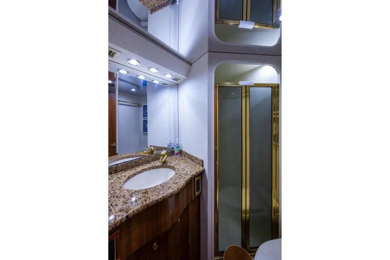 Slide: The Image of Luxurious bathroom in 2005 Viking 61 yacht with granite countertop and glass shower. - 79