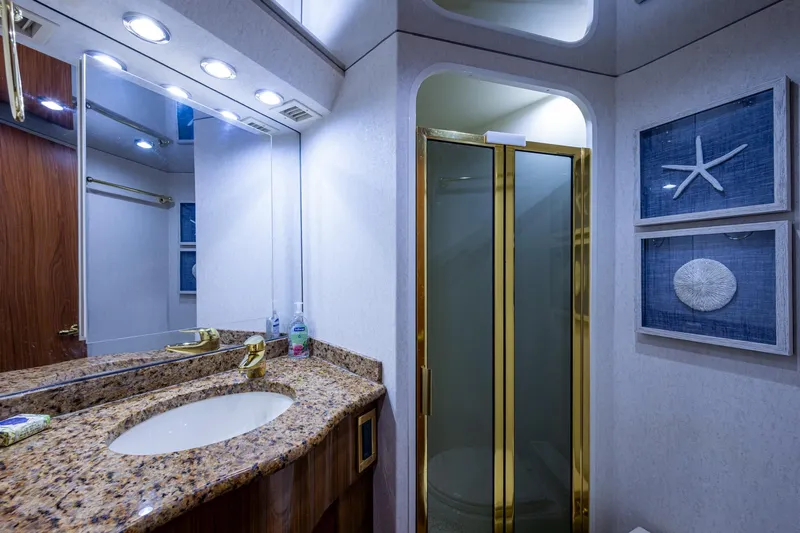 Slide: The Image of Luxurious bathroom in 2005 Viking 61 yacht with granite countertop and gold accents. - 80