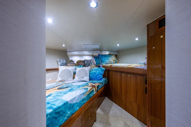 Slide: The Image of Luxurious cabin interior of 2005 Viking 61 yacht with ocean-themed bedding. - 83