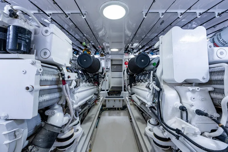 Slide: The Image of Engine room of a 2005 Viking 61 yacht, showcasing dual engines and mechanical components. - 92