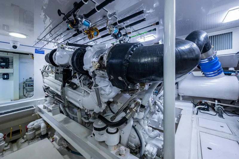 Slide: The Image of Engine room of a 2005 Viking 61 yacht, showcasing complex machinery and piping. - 94