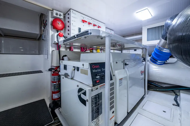 Slide: The Image of Engine room of 2005 Viking 61 yacht with Onan marine generator and fire safety equipment. - 96
