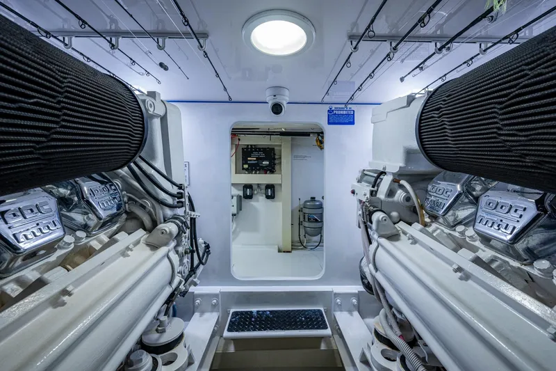 Slide: The Image of Engine room of a 2005 Viking 61 yacht, featuring dual engines and modern equipment. - 97