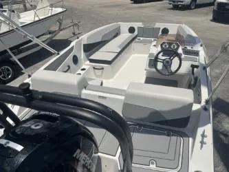 Slide: The Image of 2025 Starcraft SV 16 boat with seating, steering wheel, and Mercury engine in a marina. - 7