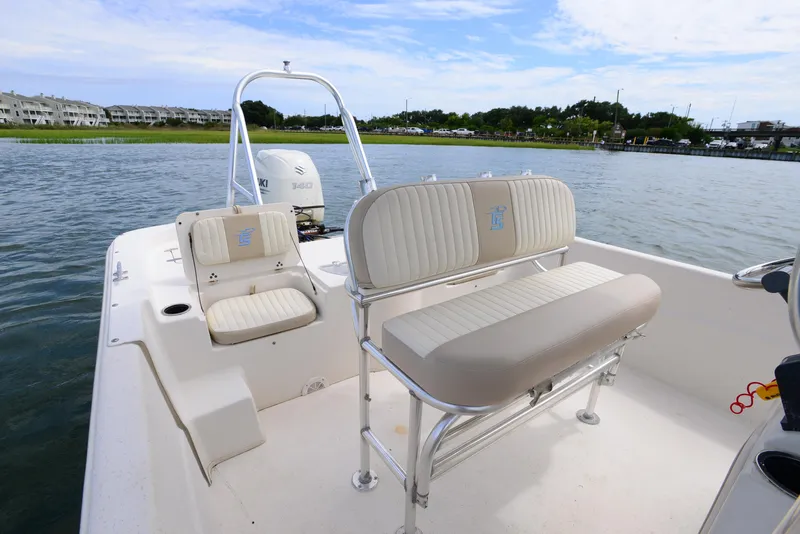 Slide: The Image of 2017 Carolina Skiff 218 DLV boat interior with seating, on calm water. - 14