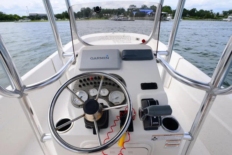 Slide: The Image of 2017 Carolina Skiff 218 DLV boat console with Garmin navigation on a calm waterway. - 15