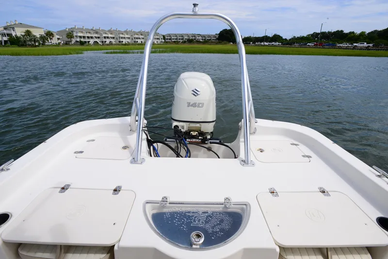 Slide: The Image of 2017 Carolina Skiff 218 DLV boat with Suzuki 140 engine on calm water. - 16