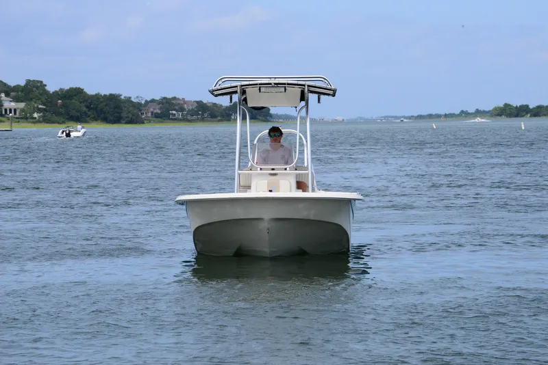 Slide: The Image of 2017 Carolina Skiff 218 DLV boat cruising on a calm waterway. - 3