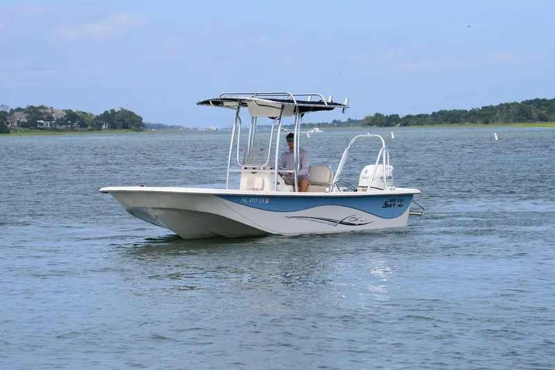 Slide: The Image of 2017 Carolina Skiff 218 DLV boat cruising on a calm lake. - 4