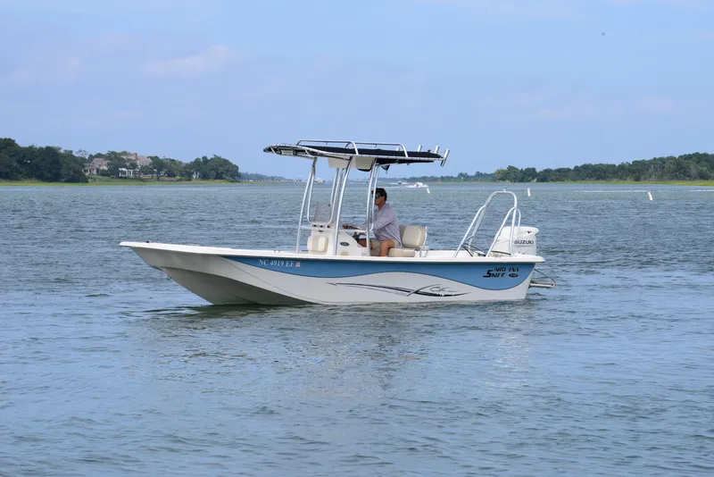 Slide: The Image of 2017 Carolina Skiff 218 DLV boat cruising on a calm lake. - 5