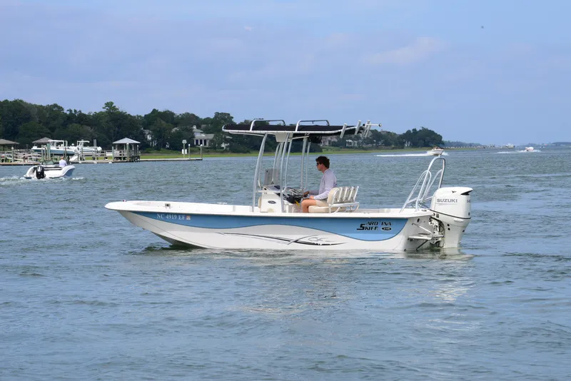 Slide: The Image of 2017 Carolina Skiff 218 DLV boat cruising on a calm waterway. - 6