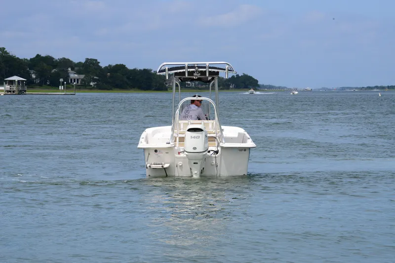 Slide: The Image of 2017 Carolina Skiff 218 DLV boat cruising on a calm waterway. - 7