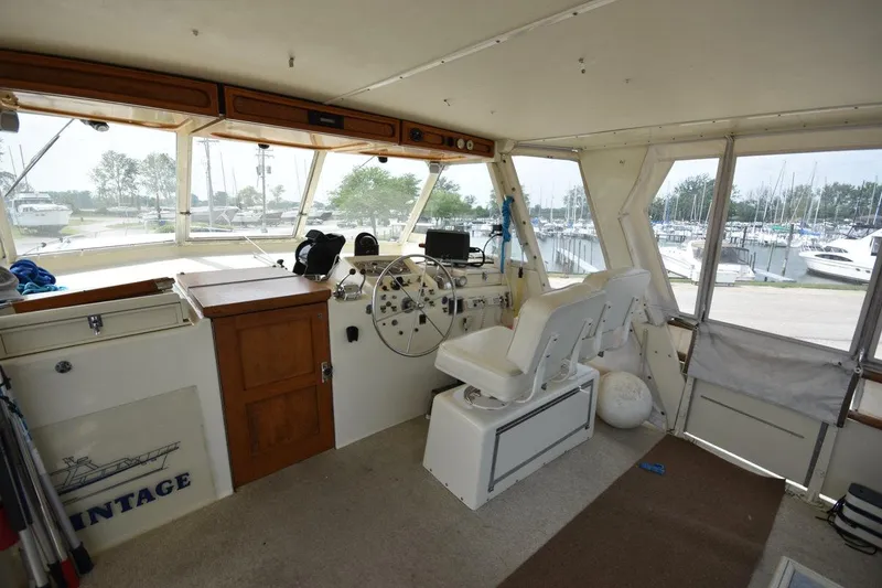 Slide: The Image of Interior of 1967 Hatteras 41 Twin Cabin yacht with helm and seating area. - 11