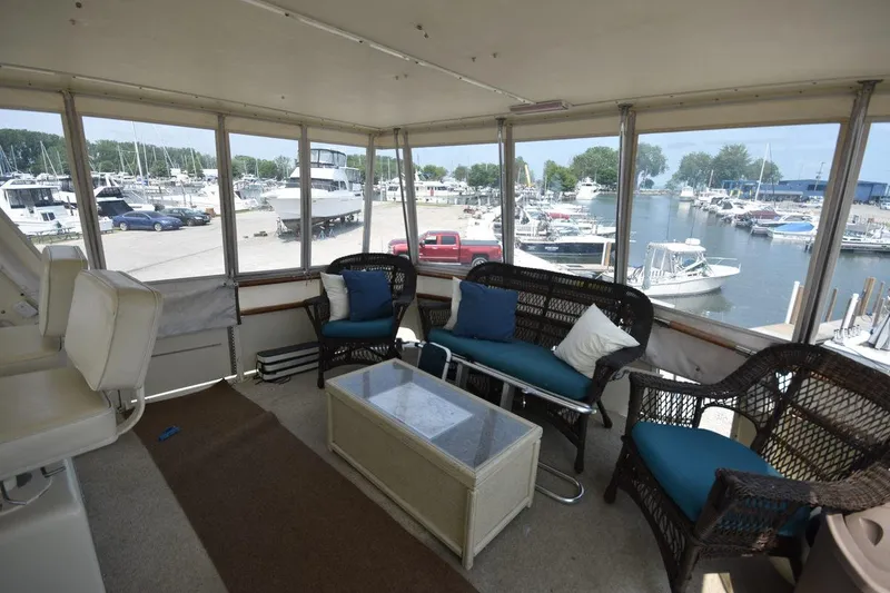 Slide: The Image of Enclosed cabin of 1967 Hatteras 41 Twin Cabin yacht with marina view. - 13