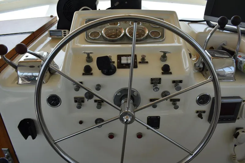 Slide: The Image of Helm of 1967 Hatteras 41 Twin Cabin with steering wheel and control panel. - 16