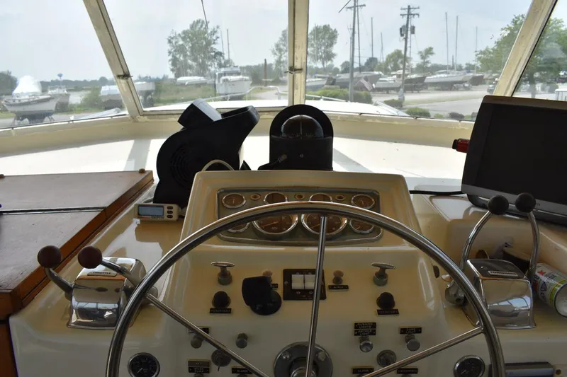 Slide: The Image of Helm of 1967 Hatteras 41 Twin Cabin with steering wheel and control panel. - 17