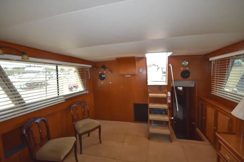 Slide: The Image of Interior of 1967 Hatteras 41 Twin Cabin with wooden decor and seating. - 22