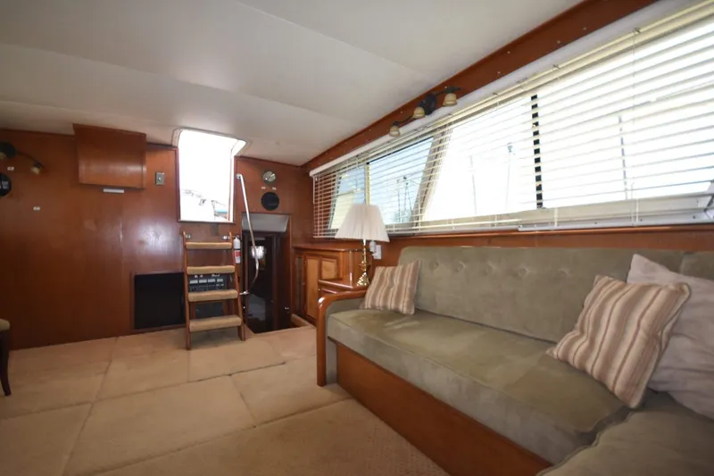 Slide: The Image of Interior of 1967 Hatteras 41 Twin Cabin with sofa, wooden paneling, and ladder. - 23