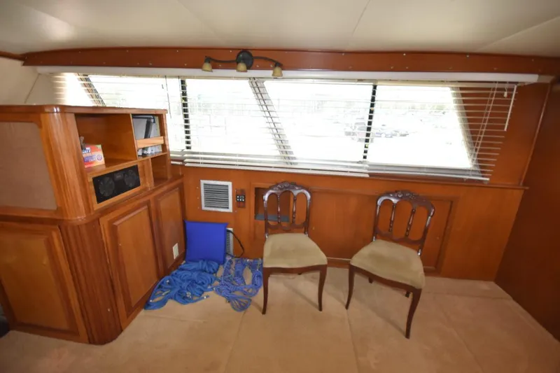 Slide: The Image of Interior of 1967 Hatteras 41 Twin Cabin with wooden furniture and two chairs. - 24