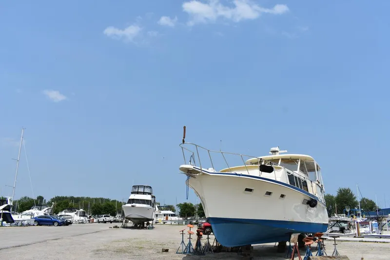 Slide: The Image of 1967 Hatteras 41 Twin Cabin yacht on dry dock under clear blue sky. - 3