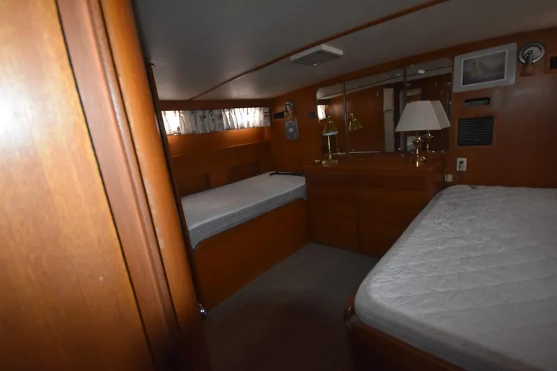 Slide: The Image of 1967 Hatteras 41 Twin Cabin interior with twin beds and wooden furnishings. - 33