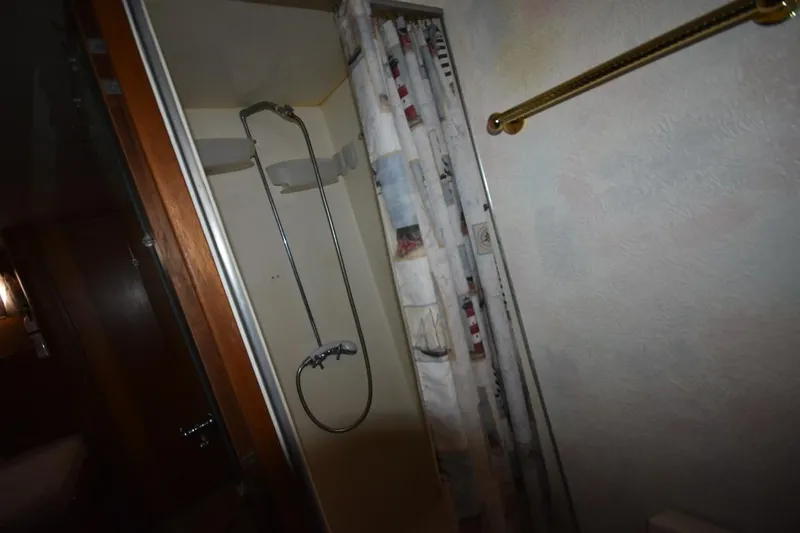 Slide: The Image of Shower area in 1967 Hatteras 41 Twin Cabin yacht with nautical-themed curtain. - 37