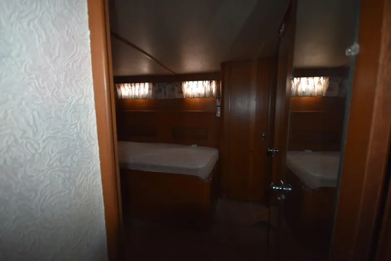 Slide: The Image of 1967 Hatteras 41 Twin Cabin interior with wood paneling and twin beds. - 39