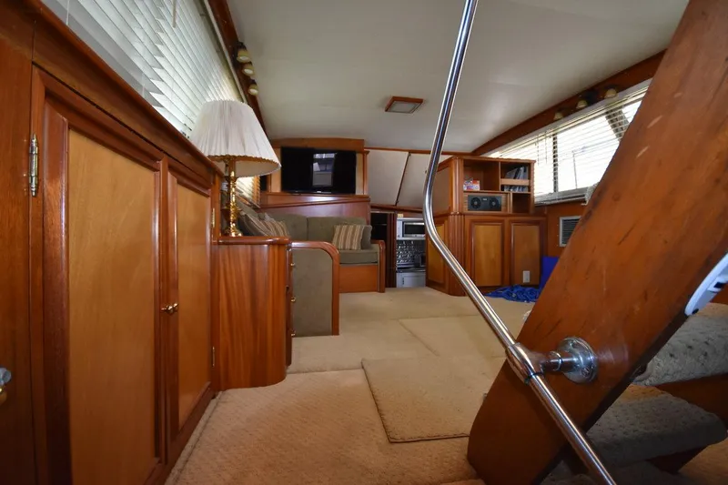 Slide: The Image of Interior of 1967 Hatteras 41 Twin Cabin with wood paneling and cozy seating area. - 40