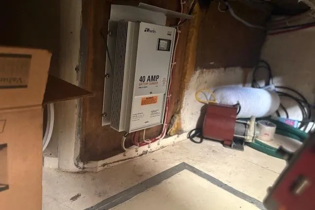 Slide: The Image of Electrical setup in a 1967 Hatteras 41 Twin Cabin boat, featuring a 40 AMP battery charger. - 42