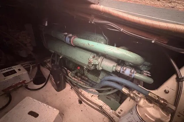 Slide: The Image of Engine room of a 1967 Hatteras 41 Twin Cabin boat, showcasing mechanical components. - 44